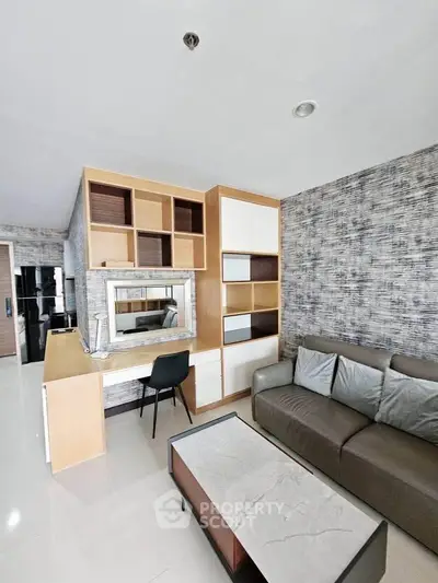 Modern living room with stylish furniture and built-in shelving in a contemporary apartment.