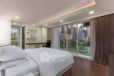Modern bedroom with city view and balcony access in luxury apartment