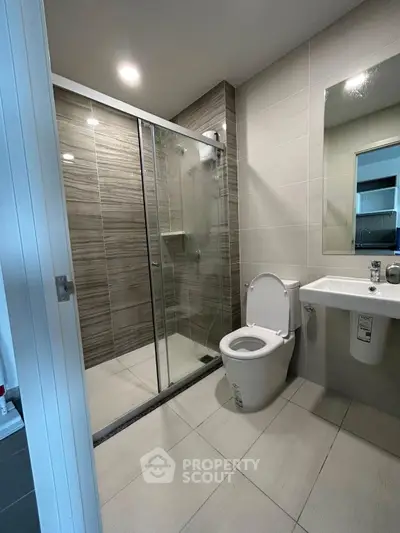 Modern bathroom with glass shower and sleek fixtures