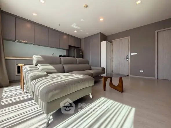 Spacious modern living room with sleek furniture and abundant natural light