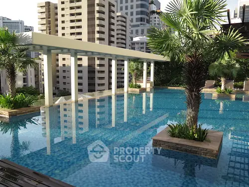 Luxurious rooftop pool with stunning cityscape views and lush greenery, perfect for relaxation and leisure.