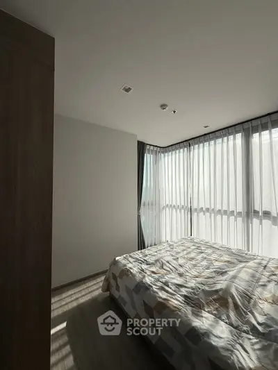 Modern bedroom with large windows and stylish decor