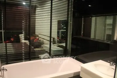 Luxurious bathroom with modern bathtub and sleek design in high-end apartment.