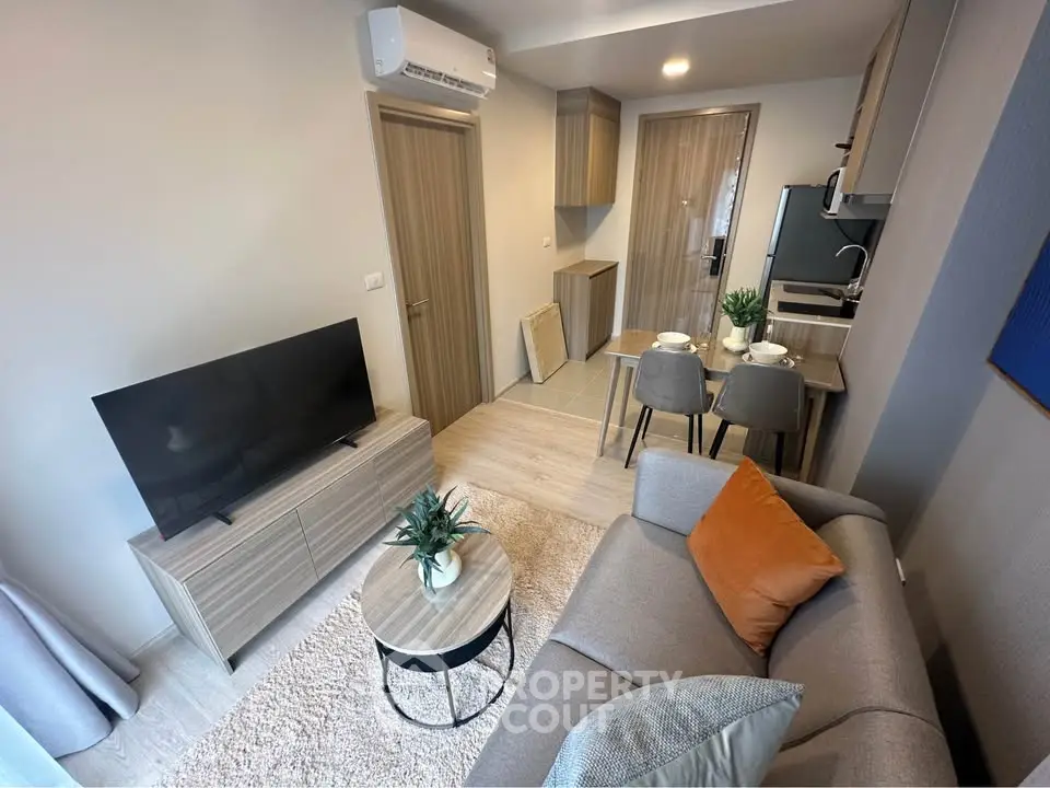 Modern living room with cozy seating and stylish decor in a compact apartment