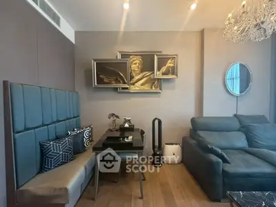 Luxurious living room with elegant decor and modern furniture, featuring a stylish chandelier and artistic wall art.