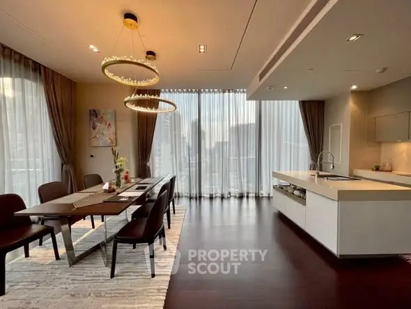 Luxurious dining and kitchen area with elegant lighting and city view.