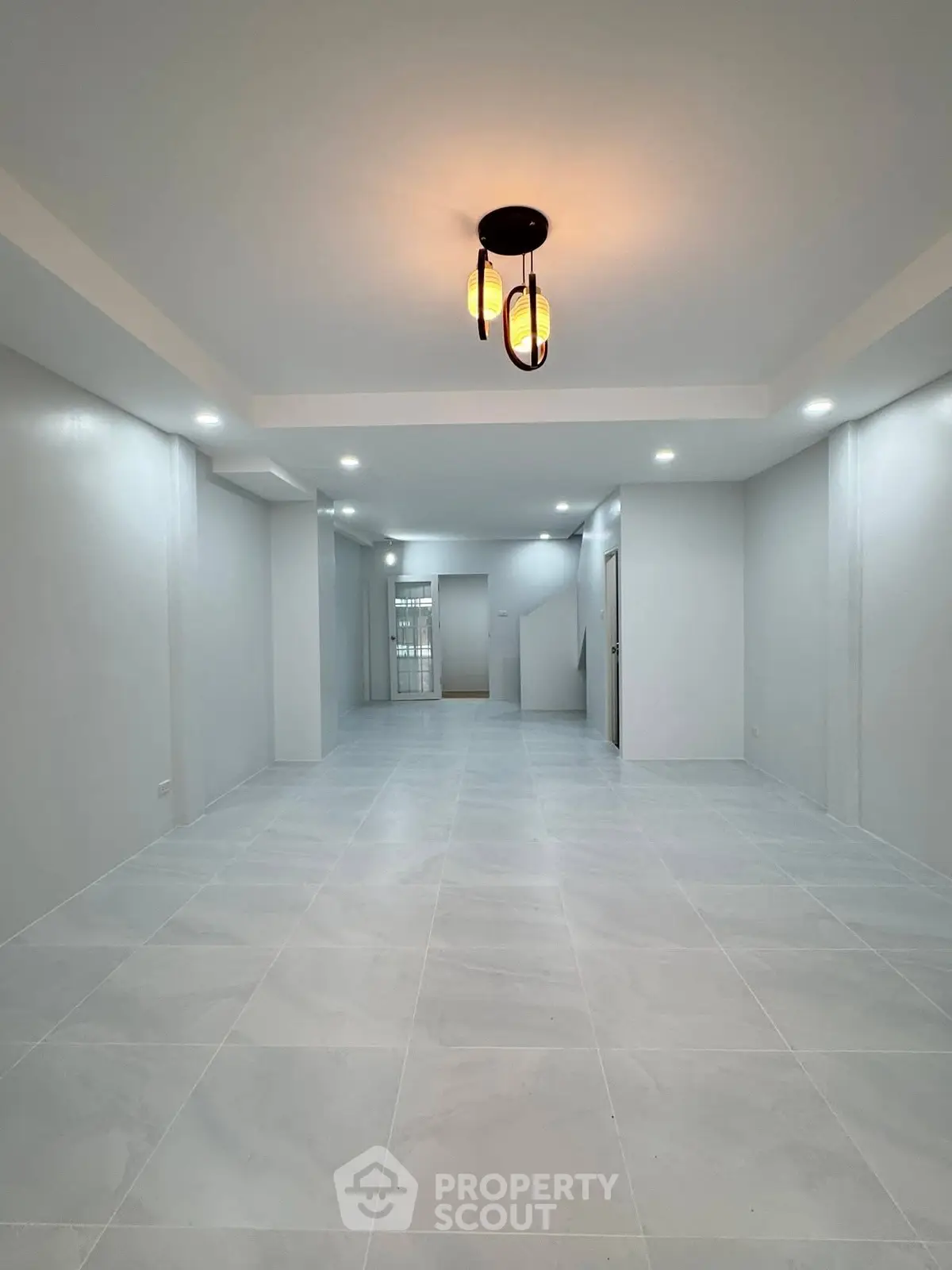 Spacious modern interior with elegant lighting and sleek tile flooring