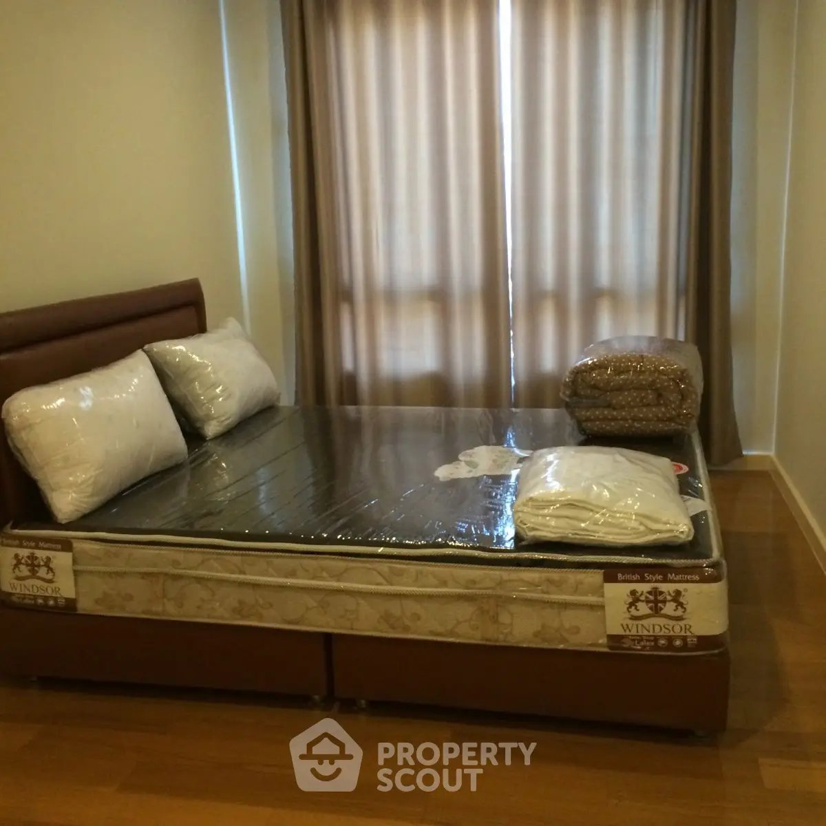 Cozy bedroom with a double bed and wooden flooring, perfect for restful nights.