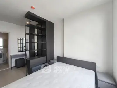 Modern bedroom with sleek furniture and ample natural light