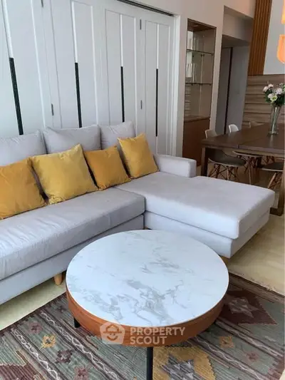 Stylish living room with modern sofa and chic marble coffee table