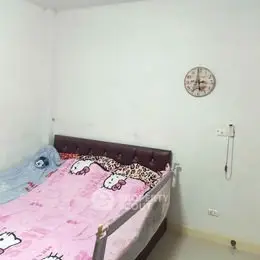 Cozy bedroom with simple decor and wall clock, ideal for relaxation.