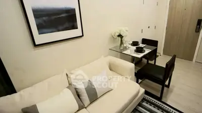 Modern living room with cozy sofa and elegant dining area in stylish apartment.