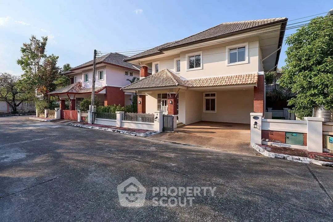 Charming suburban house with spacious driveway and lush greenery, perfect for family living.