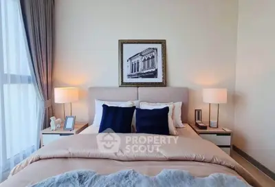 Elegant bedroom with cozy bedding and stylish decor in modern apartment.