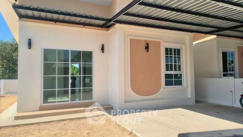 Modern single-story home with large windows and covered carport