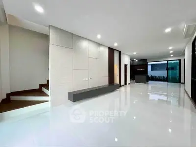 Spacious modern living room with sleek design and ample natural light.