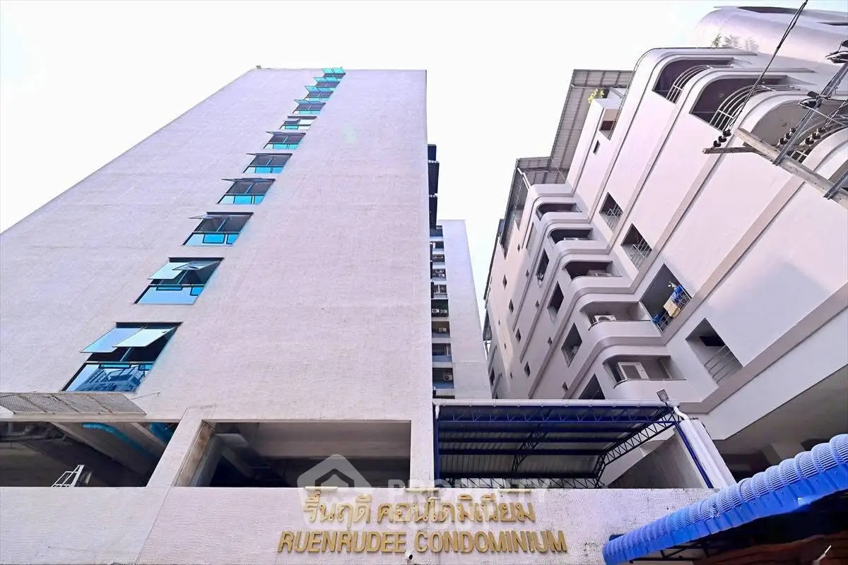 Modern condominium building exterior with unique architectural design and urban appeal.