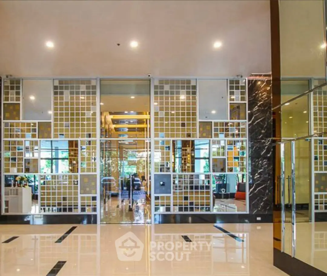 Luxurious modern building entrance with elegant design and spacious lobby area.