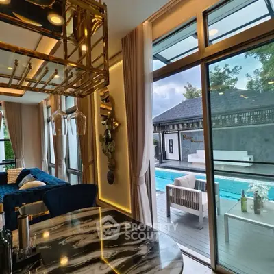 Luxurious living room with pool view and elegant decor