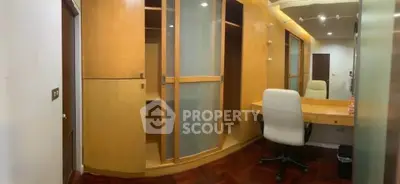 Spacious study room with built-in wooden cabinets and modern lighting.