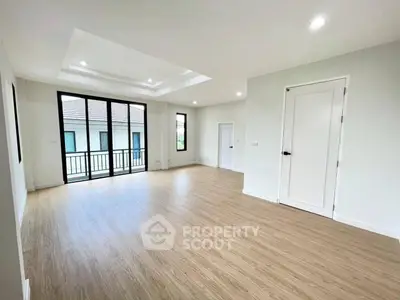 Spacious modern living room with wooden flooring and large windows