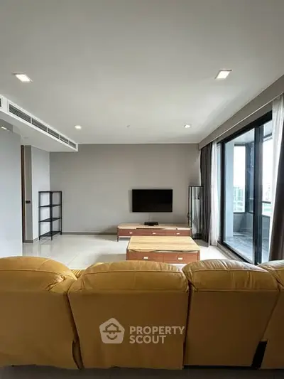 Spacious modern living room with large windows and yellow sofa, perfect for relaxation.