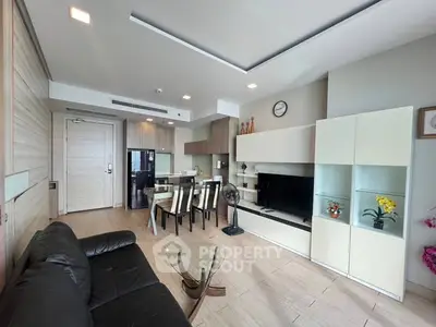 Modern open-layout living room with sleek furniture and dining area, perfect for contemporary living.