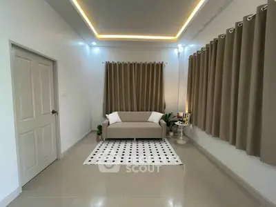Modern living room with elegant curtains and cozy sofa in a minimalist design.