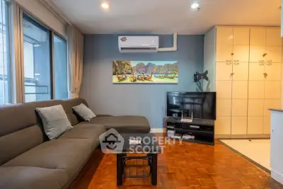 Modern living room with stylish sofa, wall-mounted TV, and air conditioning in a cozy apartment.