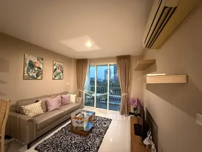 Stylish living room with modern decor and city view balcony access.