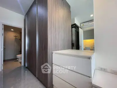 Modern apartment interior with sleek storage solutions and bathroom access