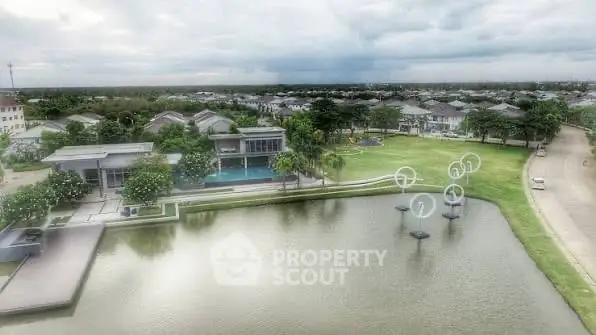 Luxurious waterfront property with modern architecture and lush green surroundings.