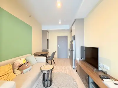 Modern living room with cozy sofa, TV, and dining area in stylish apartment.