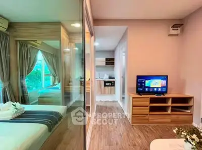 Modern apartment interior with glass partition, cozy bedroom, and stylish kitchen area.