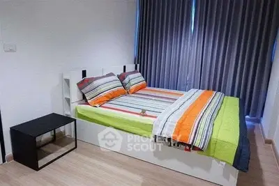Modern bedroom with colorful bedding and sleek furniture design