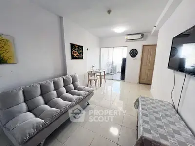 Modern living room with sleek furniture and balcony access, perfect for urban living.