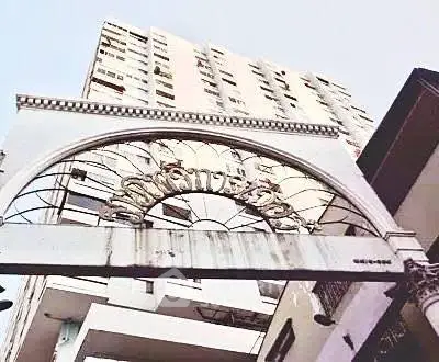 Elegant building entrance with archway and high-rise architecture