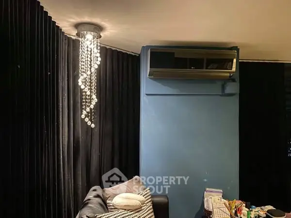 Stylish living room with modern chandelier and air conditioning unit