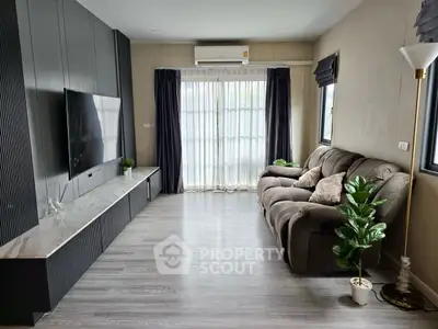 Modern living room with sleek TV setup and cozy seating area