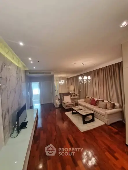 Luxurious living room with elegant decor and hardwood floors in a modern apartment.