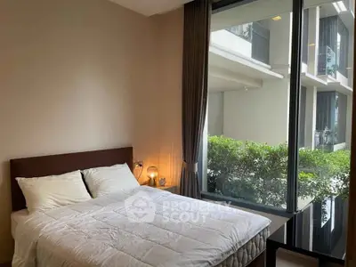 Modern bedroom with large window and garden view in luxury apartment