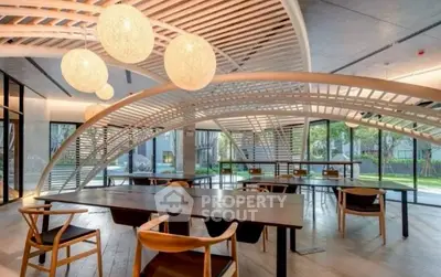 Modern communal space with stylish lighting and outdoor views