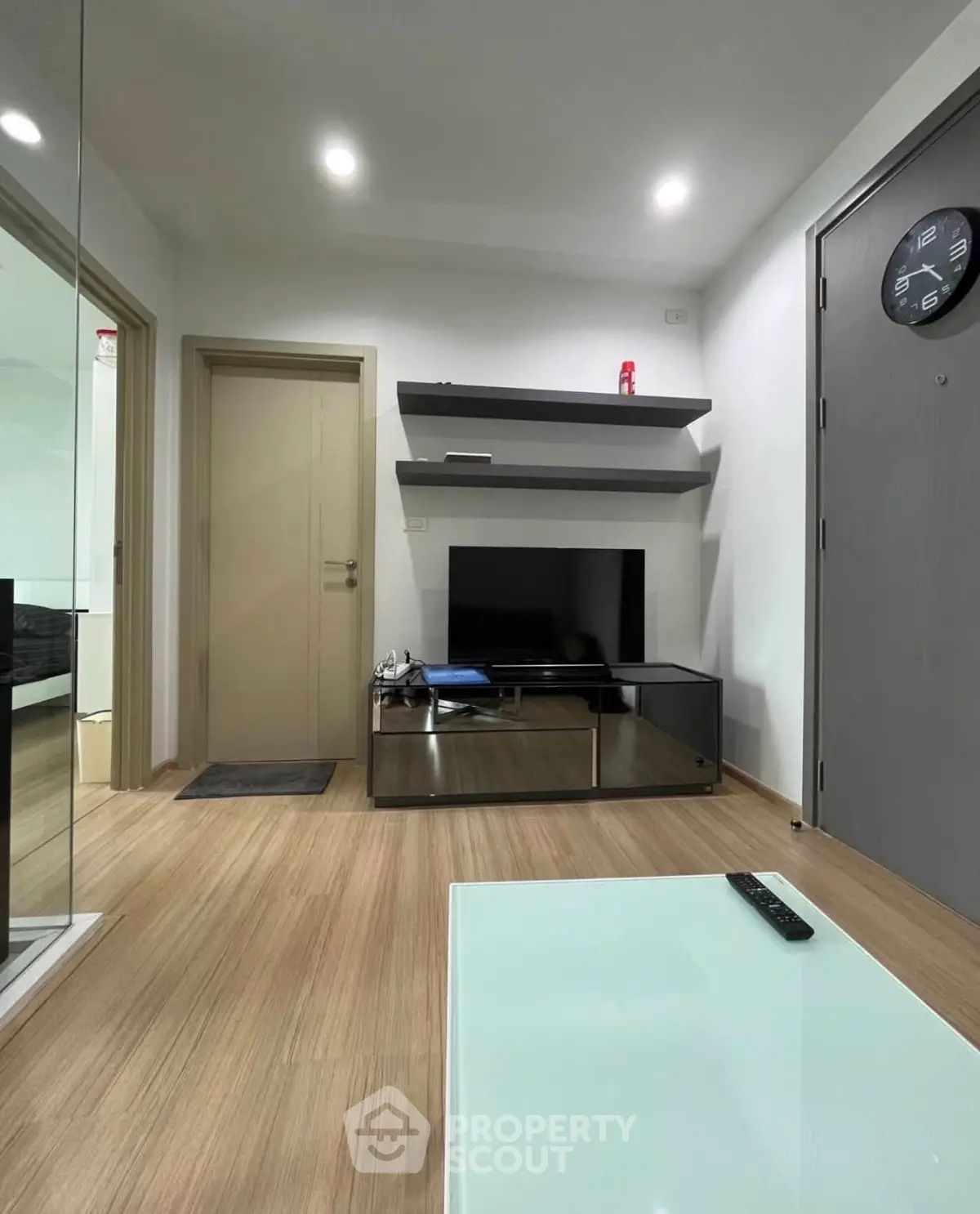 Modern living room with sleek TV stand and wooden flooring
