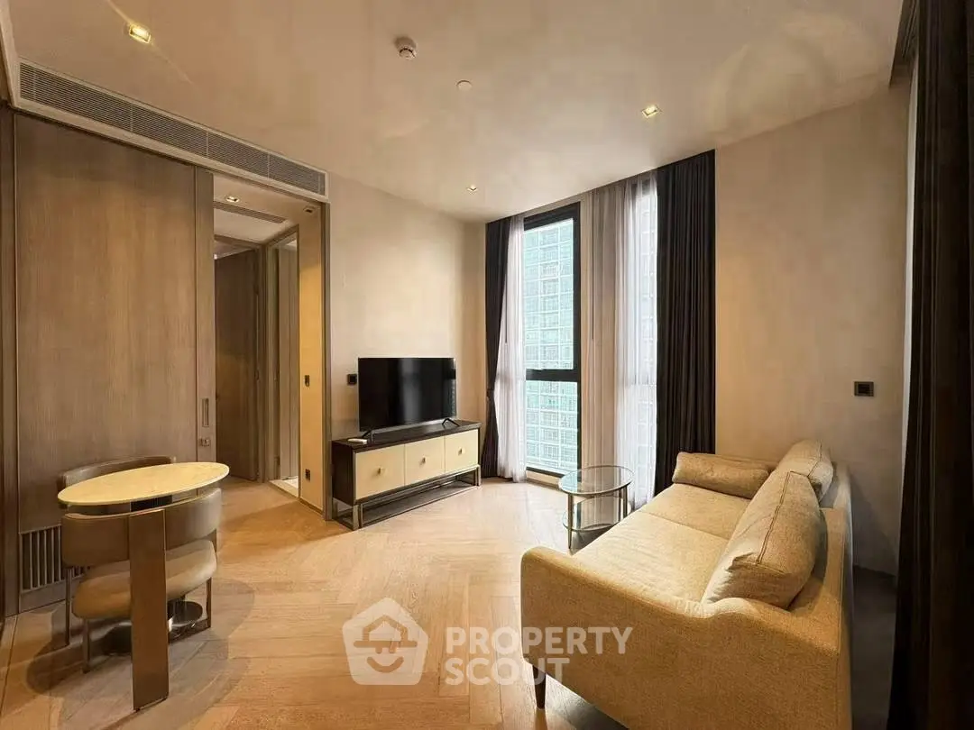 Modern living room with elegant furniture and large window offering city view