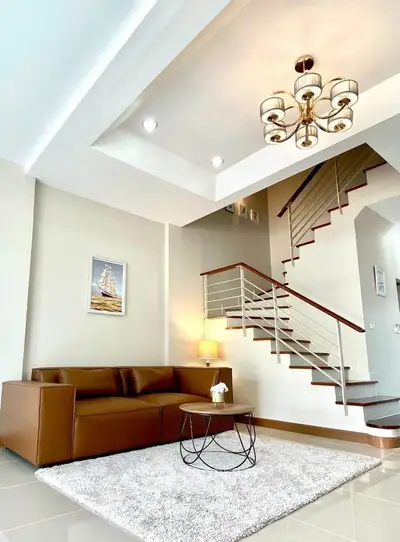 Elegant living room with modern staircase and stylish chandelier