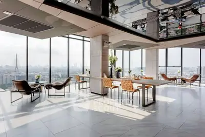 Luxurious high-rise living room with panoramic city views and modern furnishings.