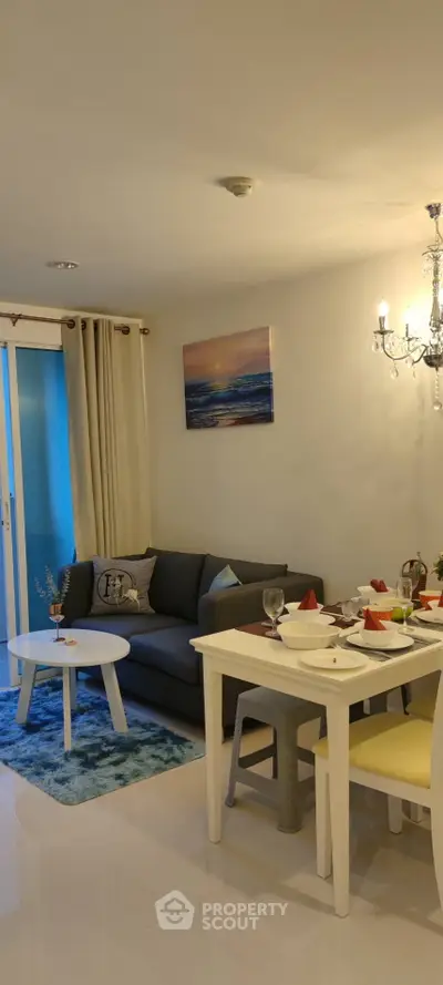 Charming living room with cozy sofa, elegant dining set, and ambient lighting in modern apartment.