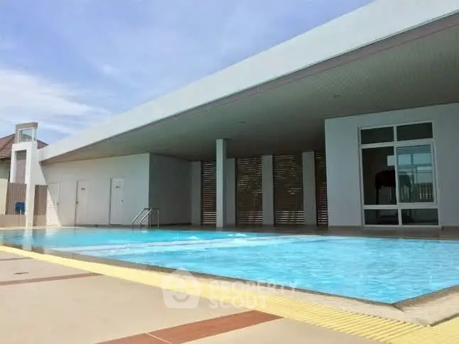 Modern rooftop pool with sleek design and spacious lounging area.