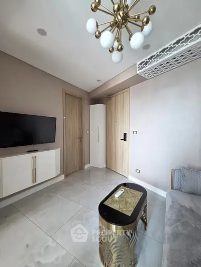 Modern living room with stylish chandelier and sleek TV setup