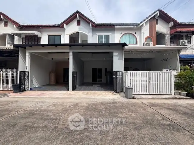 Charming townhouse with gated entrance and spacious driveway in a serene neighborhood.